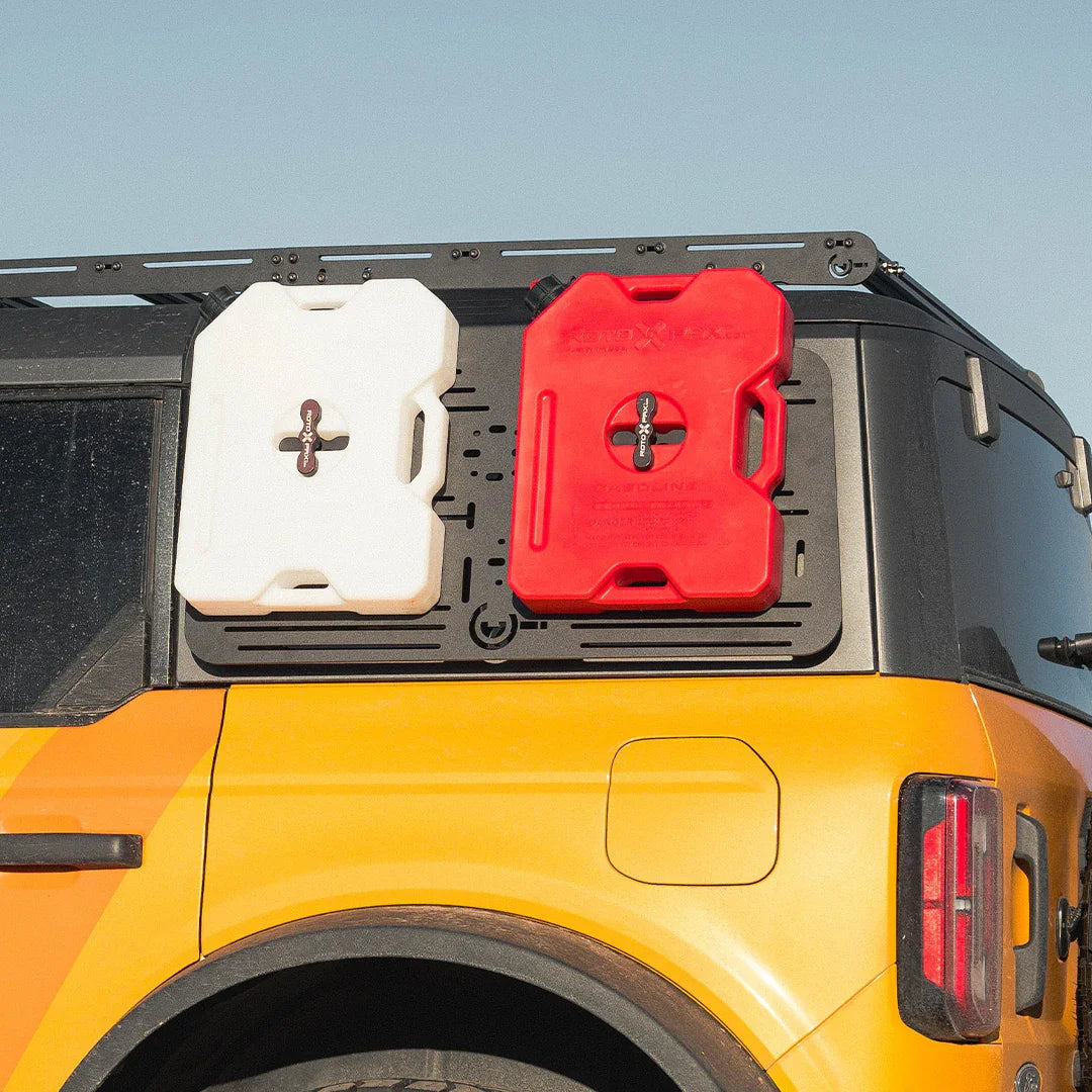 Ford Bronco accessory panel with mounted red and white fuel and water canisters