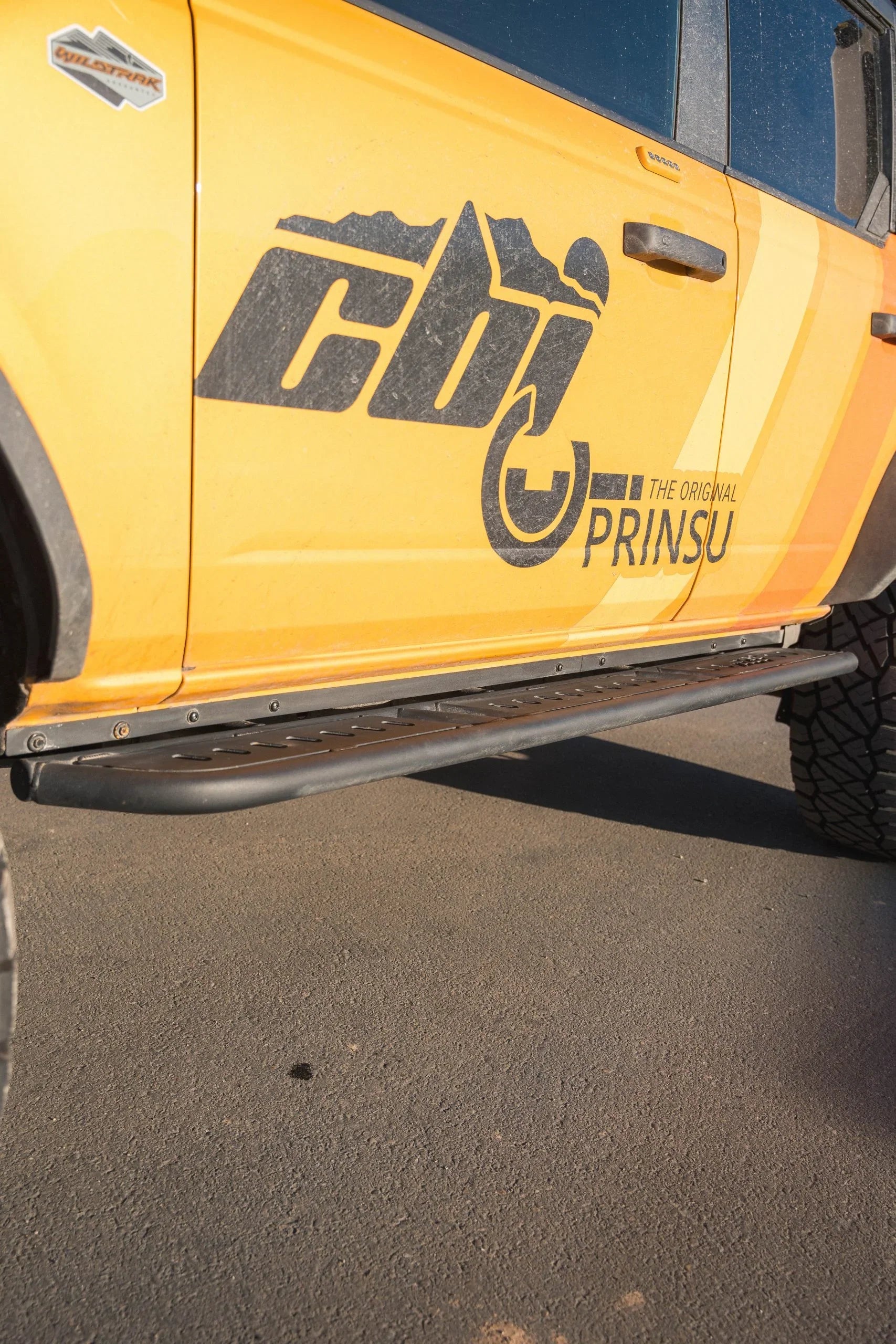 Ford Bronco with black pinch weld cover and rock slider for off-road protection