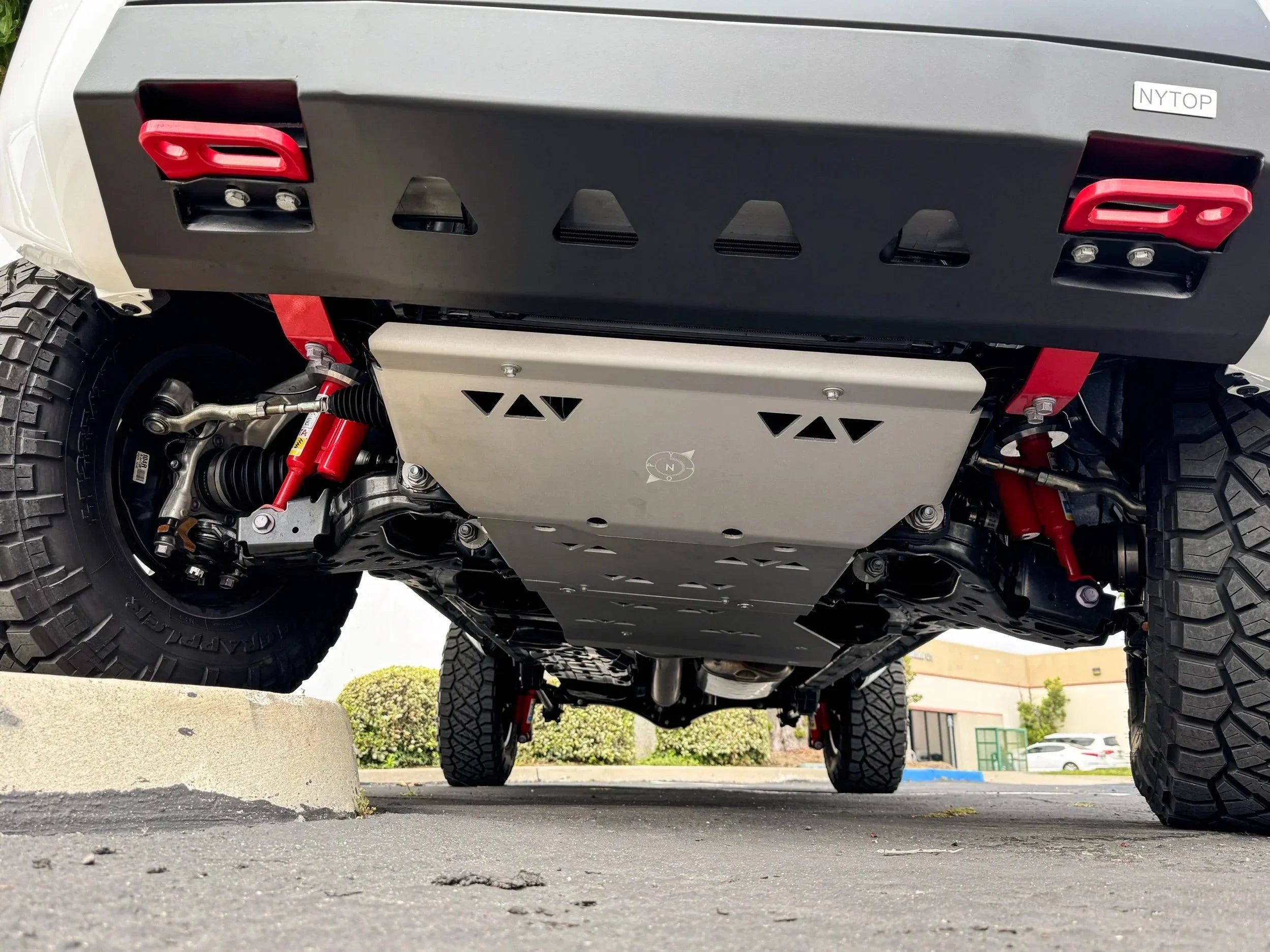 Off-road vehicle skid plate, suspension, and undercarriage with red recovery points