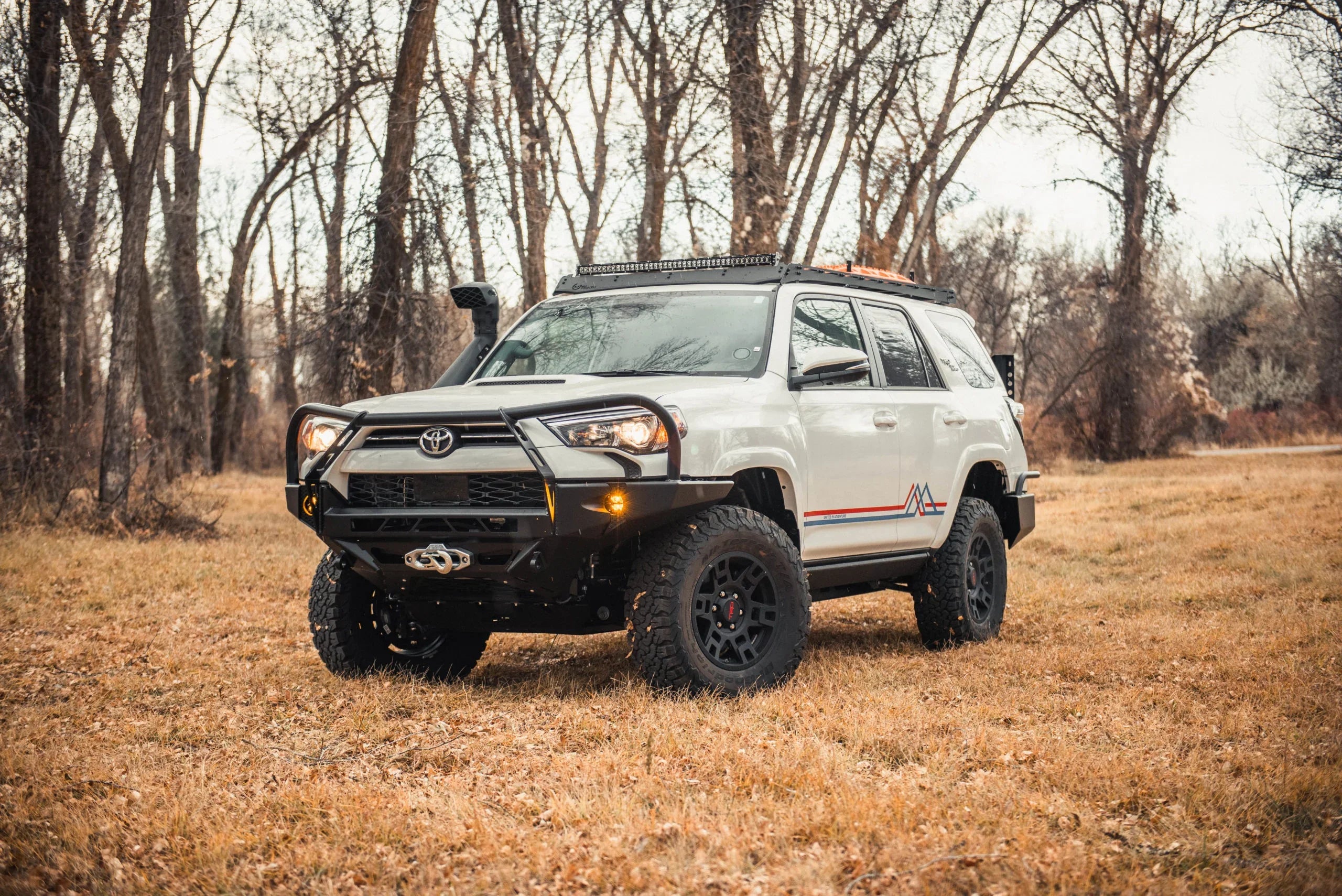 2020-2021 Toyota 4Runner with off-road adventure upgrades in a grassy forest setting