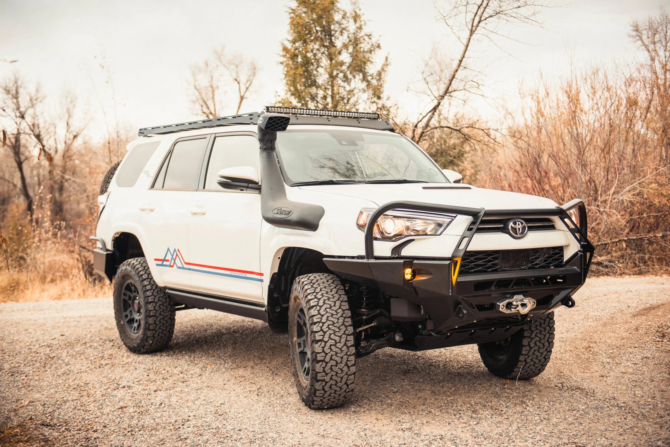 2020-2021 Toyota 4Runner with off-road front bumper, roof rack, and snorkel, parked outdoors