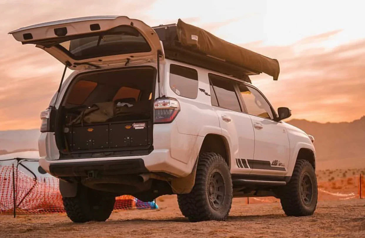 Toyota 4Runner with roof rack and trail rock sliders set up for overlanding at sunset