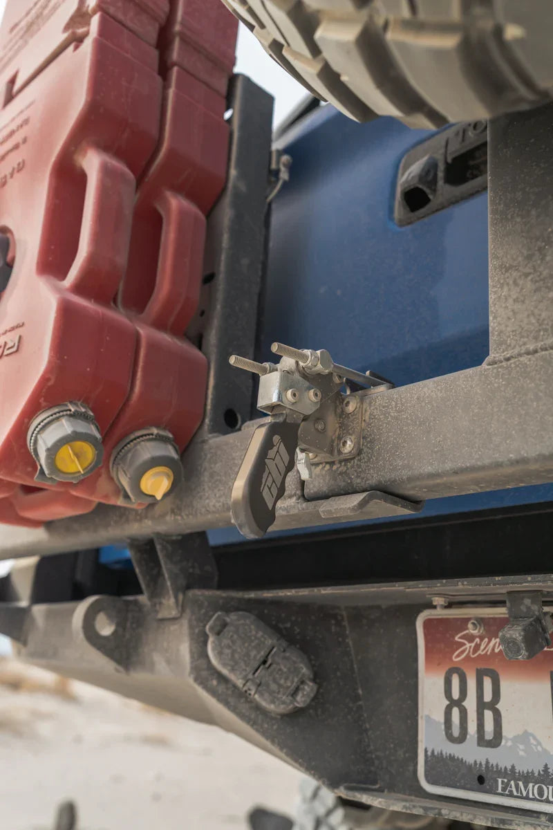 Swing away latch mechanism on off-road vehicle bumper with fuel canisters