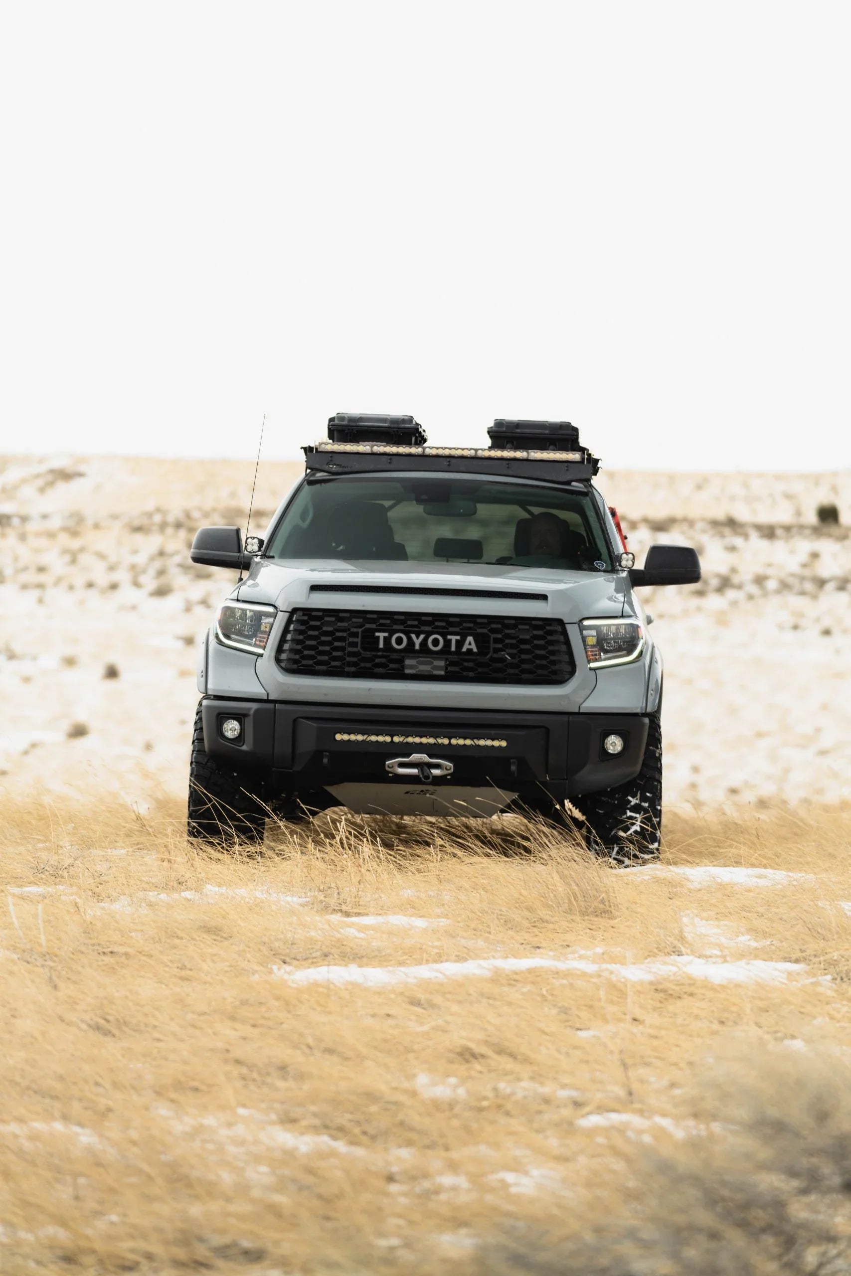 Toyota Tundra with covert front bumper and roof racks in snowy off-road landscape