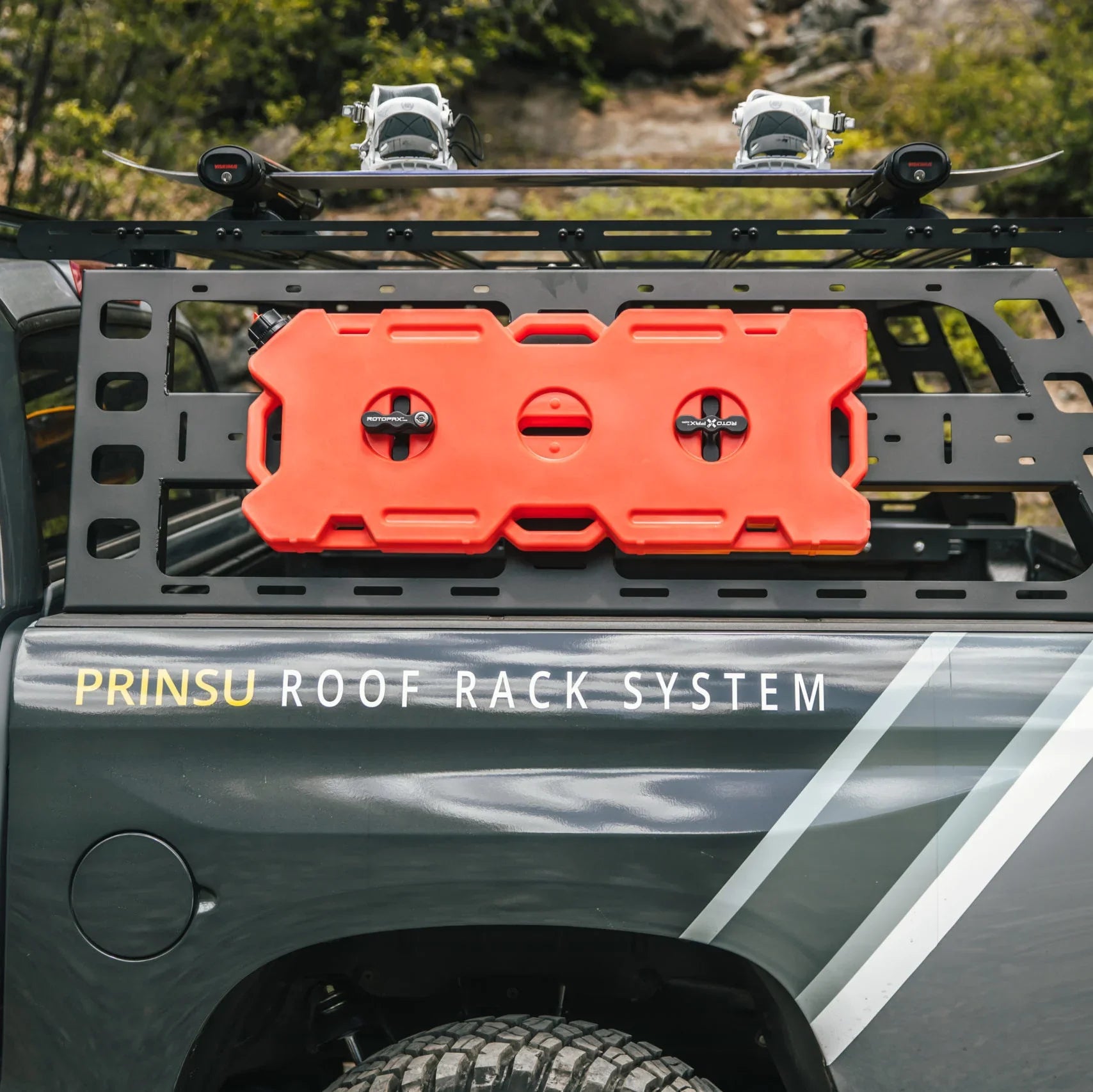 Toyota Tundra with cab height bed rack, mounted red fuel can, and roof rack system outdoors