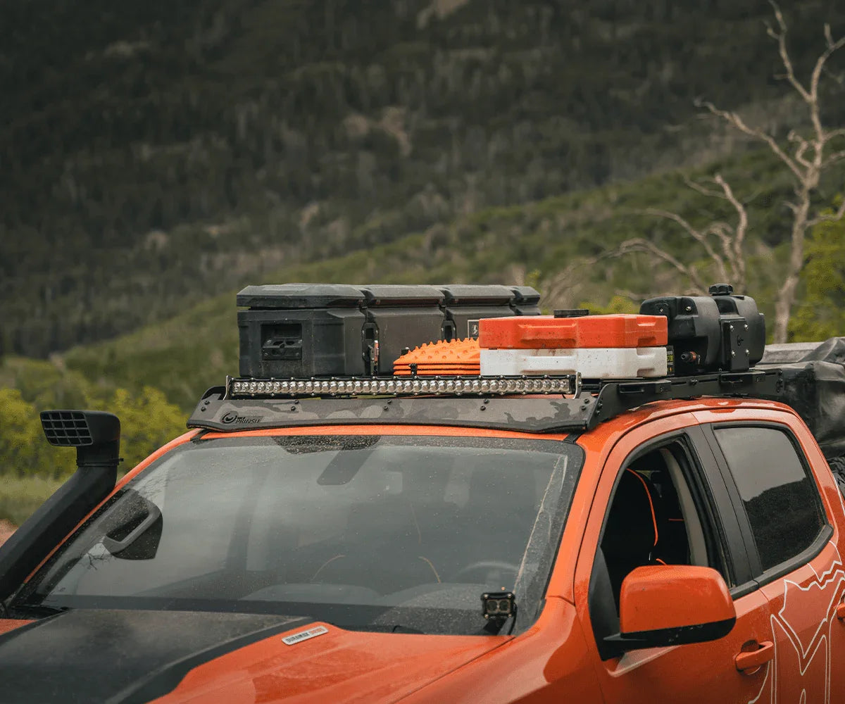 Chevy Colorado with Prinsu roof rack loaded with overlanding gear and storage boxes outdoors