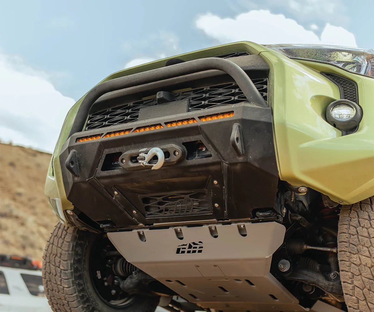 Close-up of modified Toyota 4Runner front bumper with winch and skid plate for overlanding