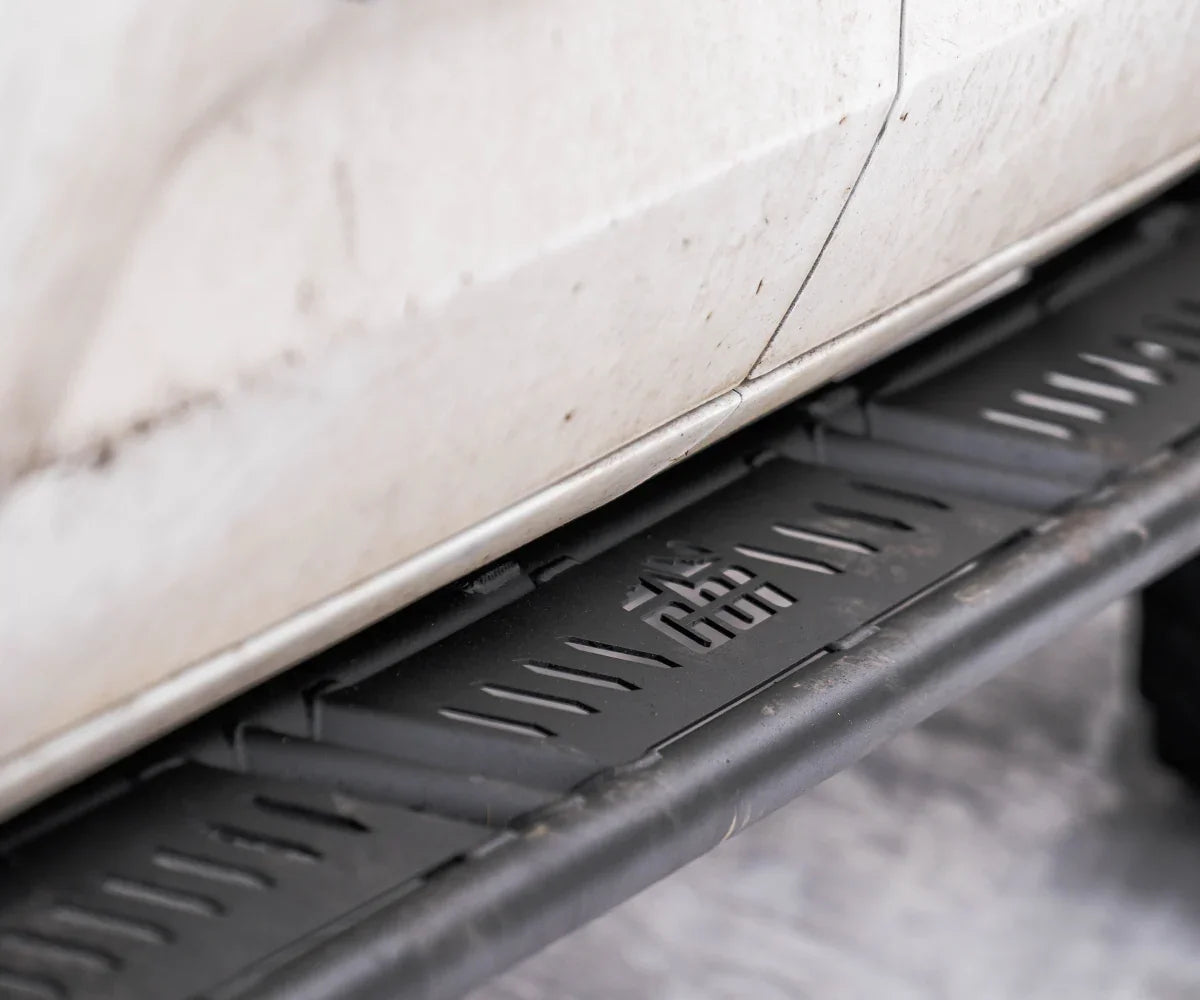 Close-up of off-road rock slider on Toyota Tundra with rugged, matte black finish
