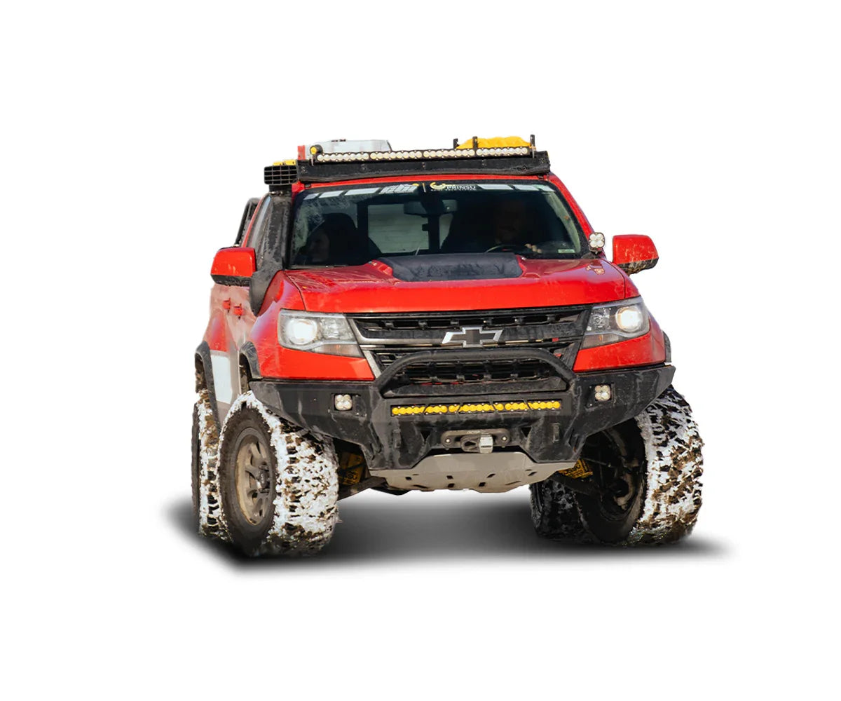 Red Chevrolet Colorado Baja off-road truck with mud tires and rooftop lights for overlanding