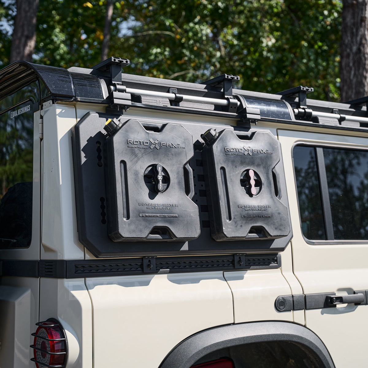 Grenadier MOLLE panel carrying two fuel cans on the rear quarter