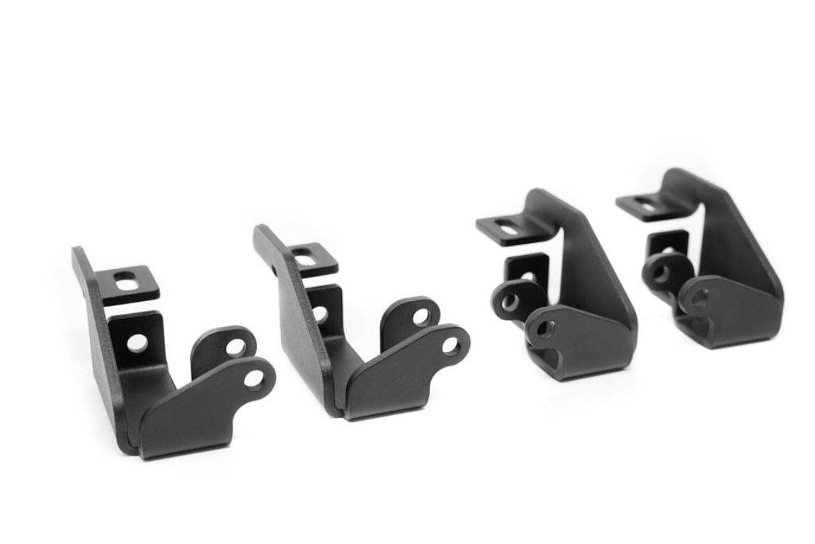 Set of four black metal mounting brackets for off-road vehicle accessories on a white background