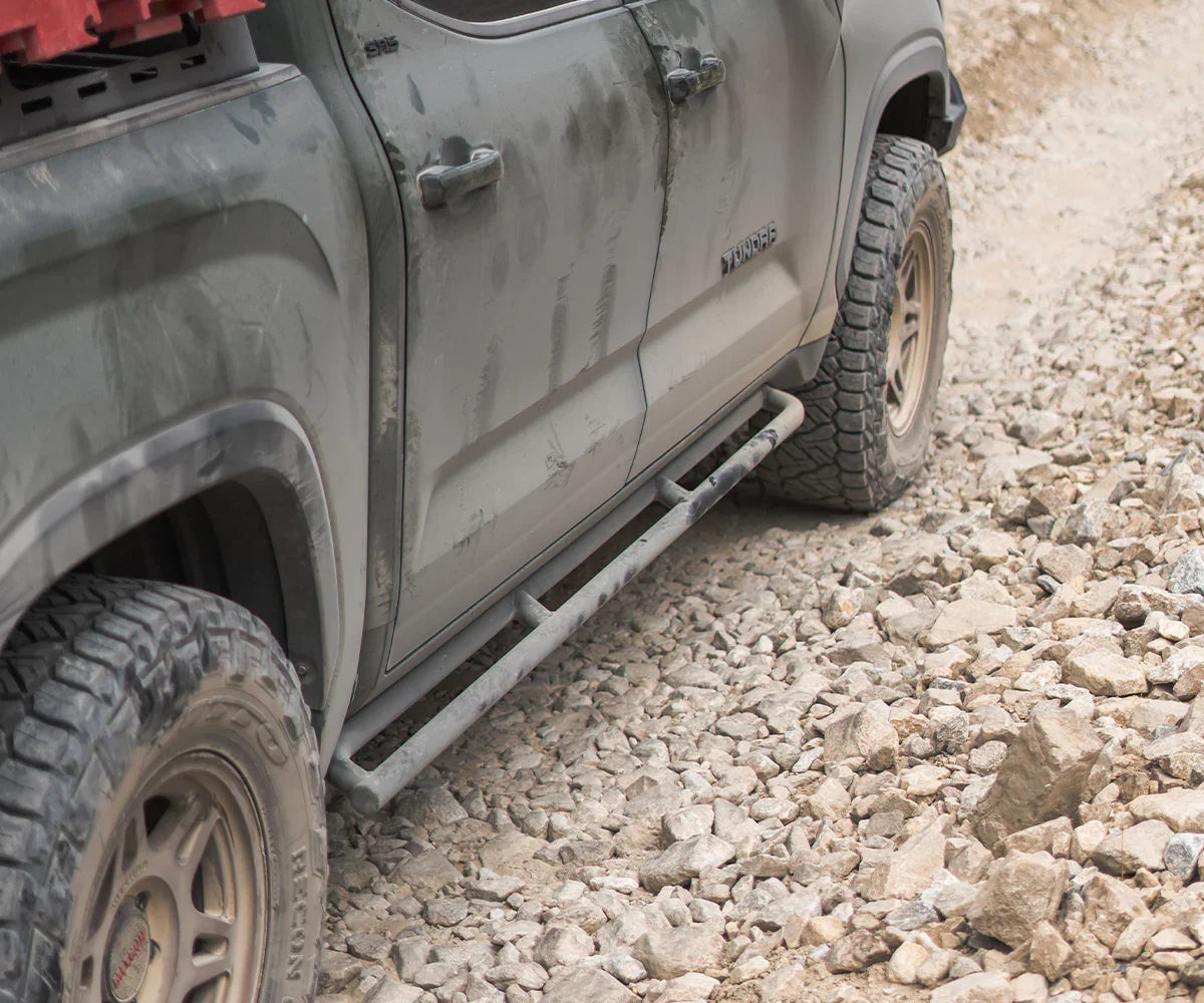 Toyota Tundra with rock sliders off-road on rocky trail