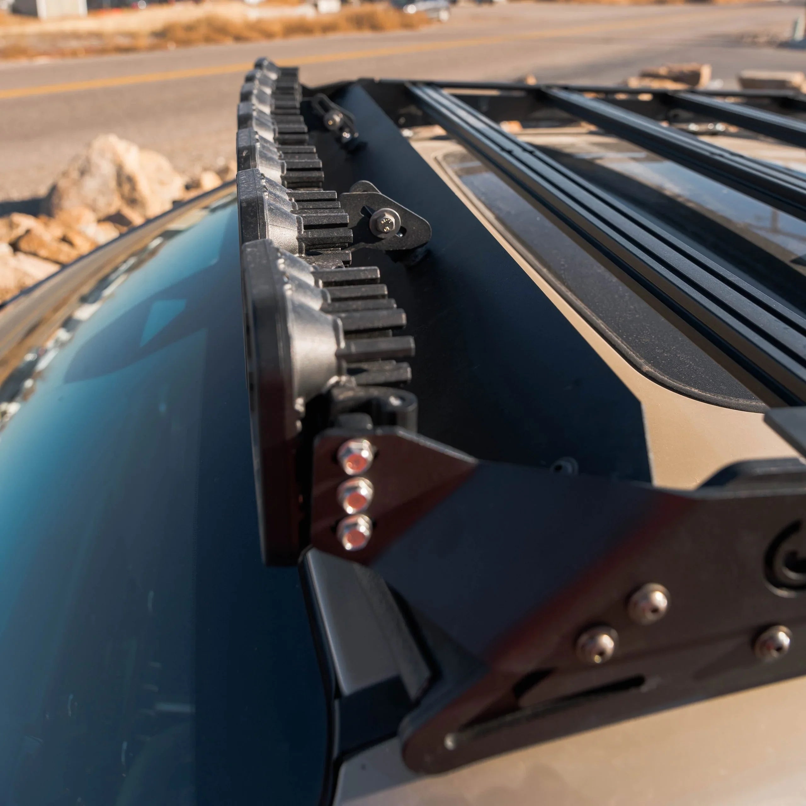 Close-up of a rugged roof rack with mounted LED light bar on a vehicle, outdoor adventure gear