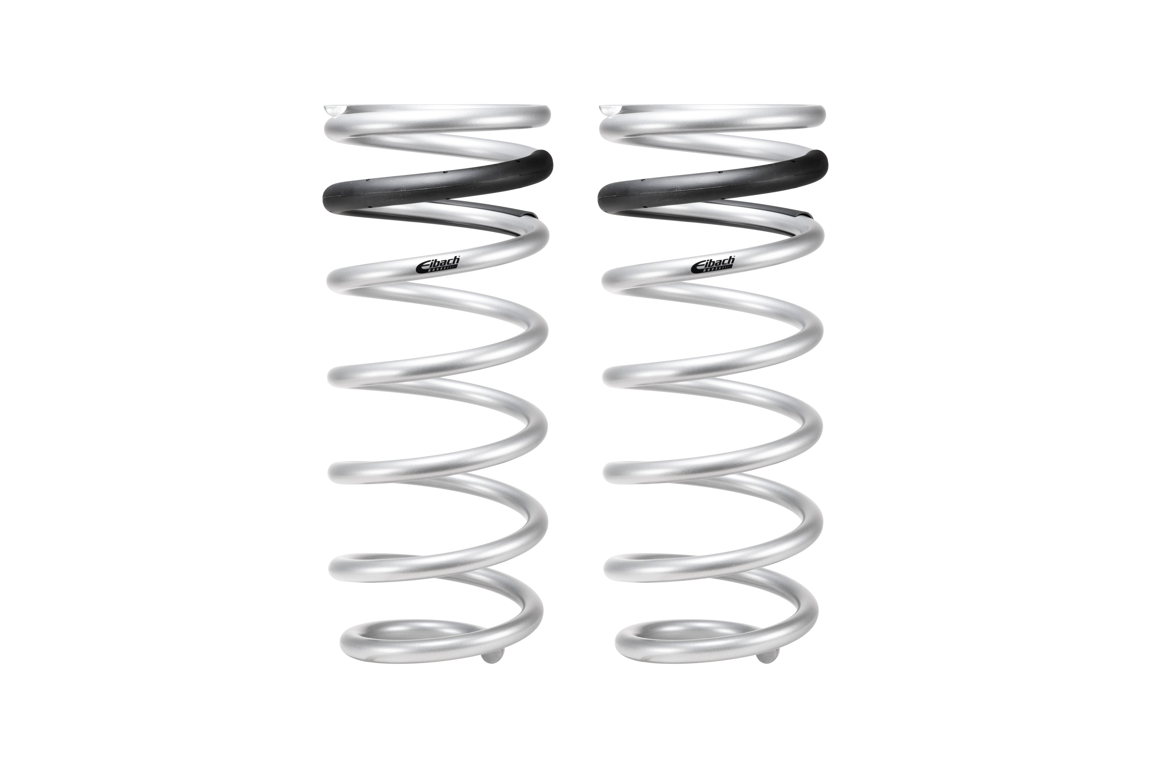 Pair of silver Eibach coil springs for off-road vehicles, isolated on white