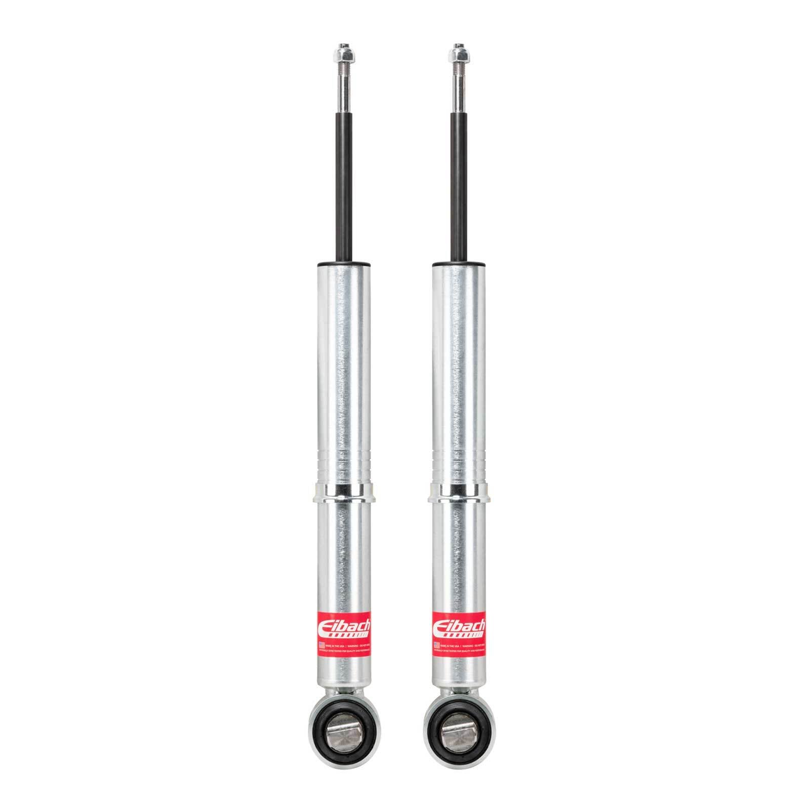 Pair of Eibach rear shocks for off-road vehicles, silver with red label, isolated on white