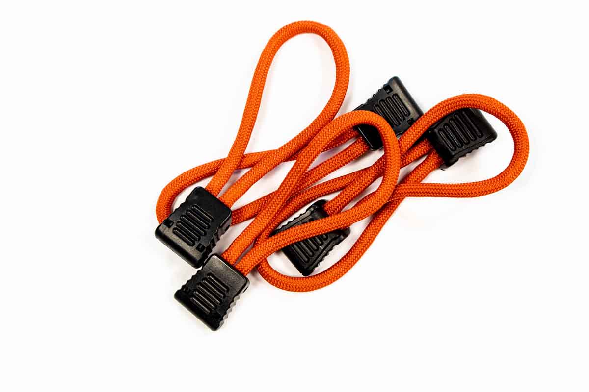 Set of orange utility bungee cords with black plastic hooks for camping or vehicle gear