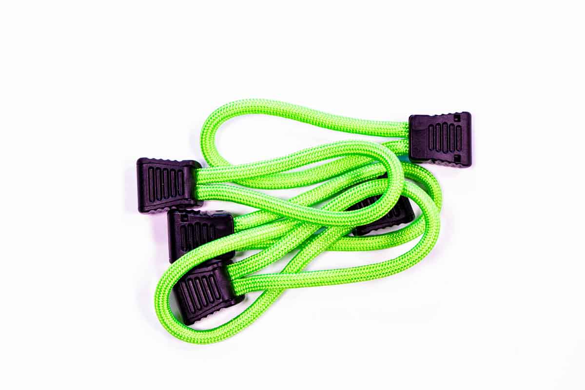 Neon green bungee cords with black plastic hooks for overlanding or camping gear tie-downs