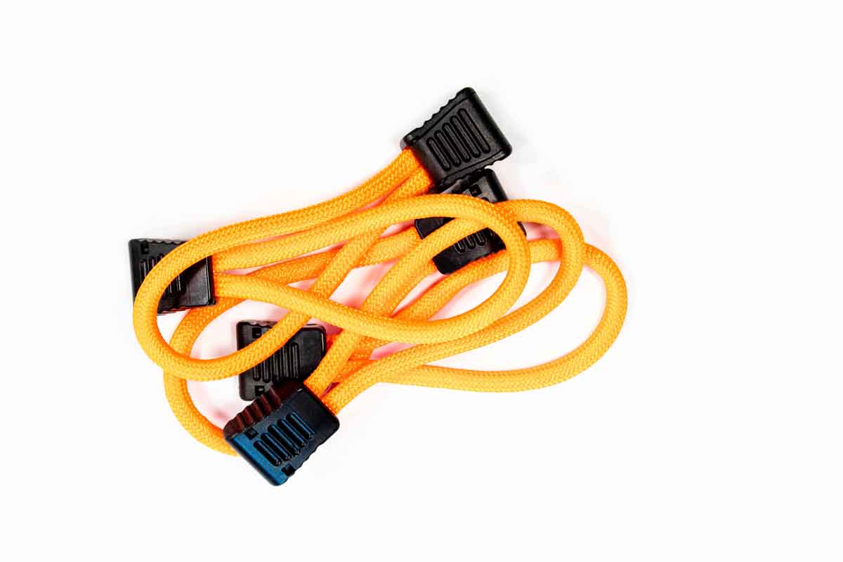 Bright orange bungee cord with black plastic hooks for overlanding or camping gear organization