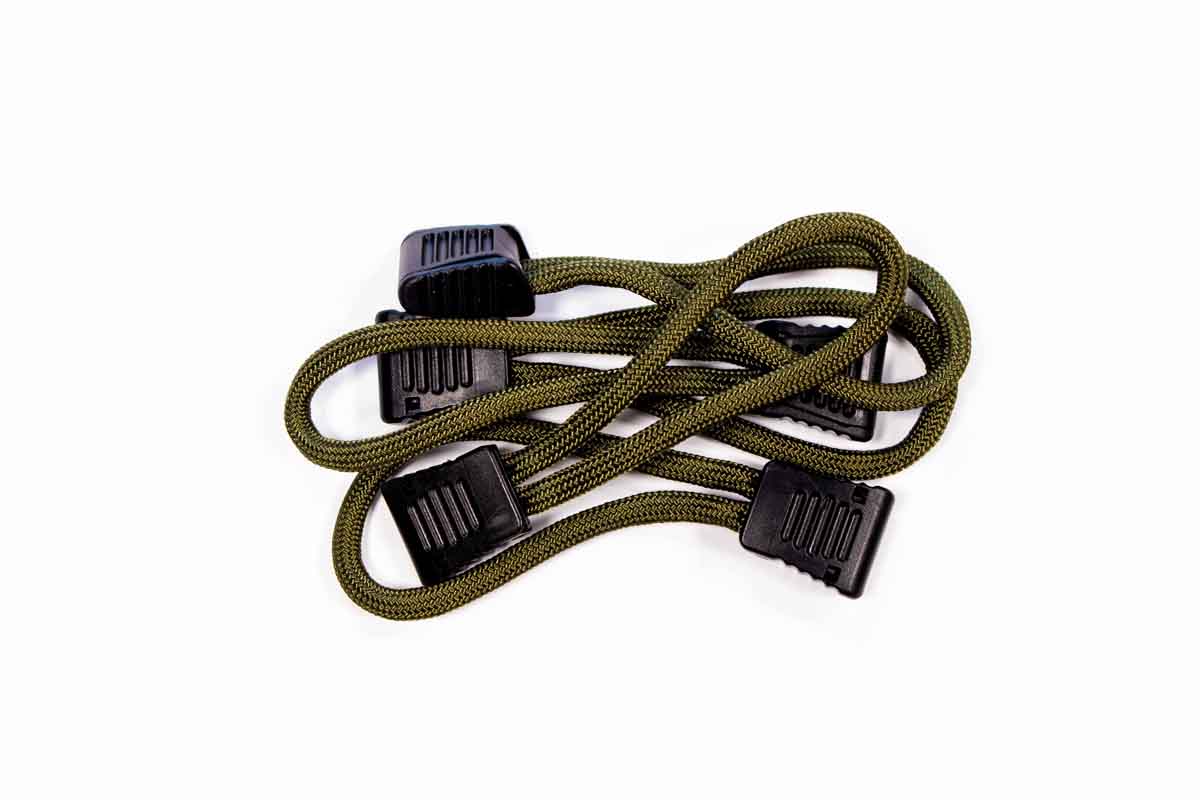 Green elastic bungee cord with black hooks for overlanding and camping gear securement