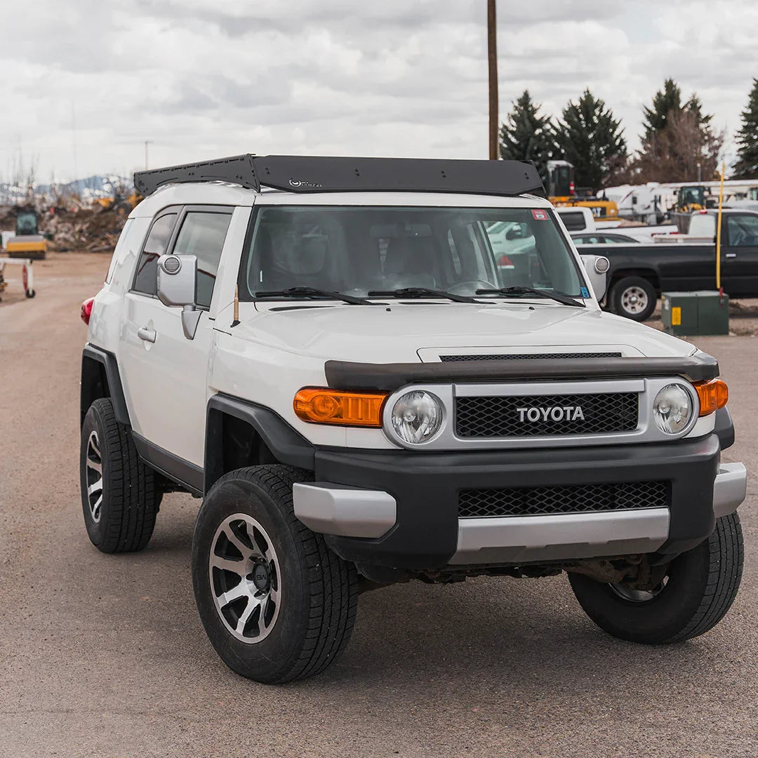 Toyota FJ Cruiser with Prinsu Pro roof rack parked outdoors, front angle view