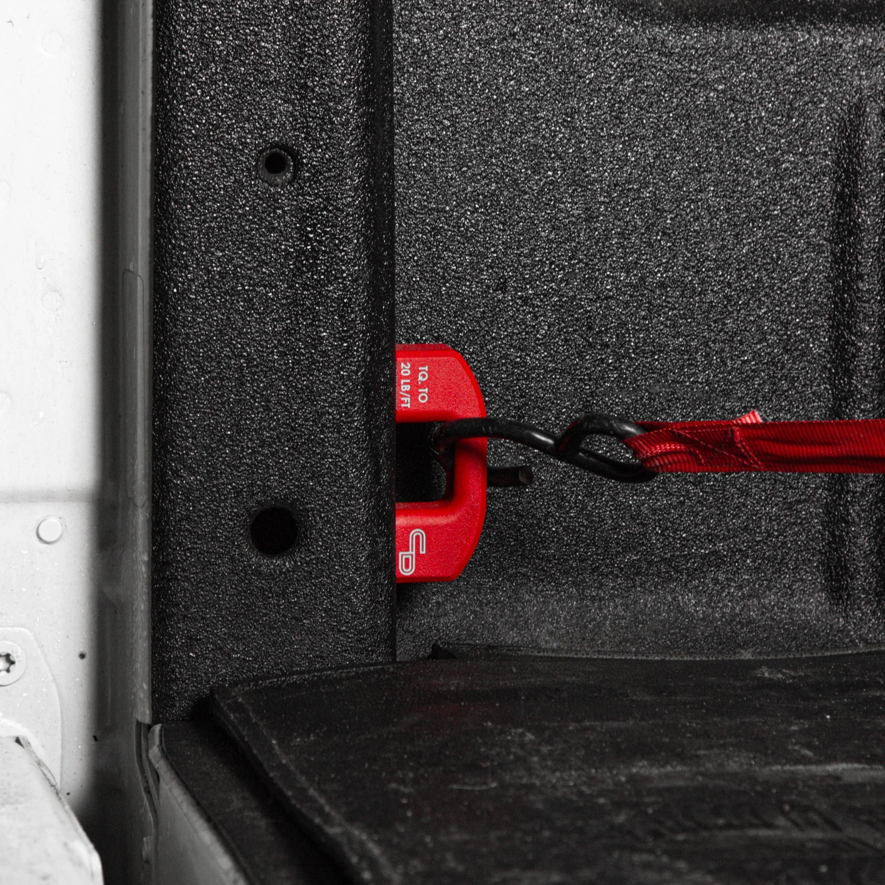 Red powder coated bed tie down installed in Ford F250 F350 Super Duty truck bed