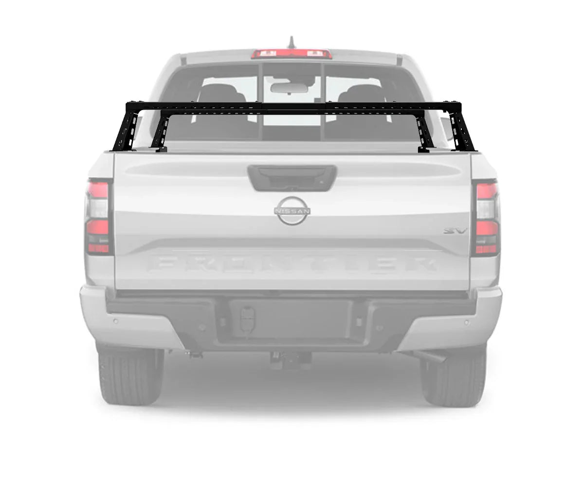 Black overland bed rack mounted on Nissan Frontier pickup truck for expedition gear