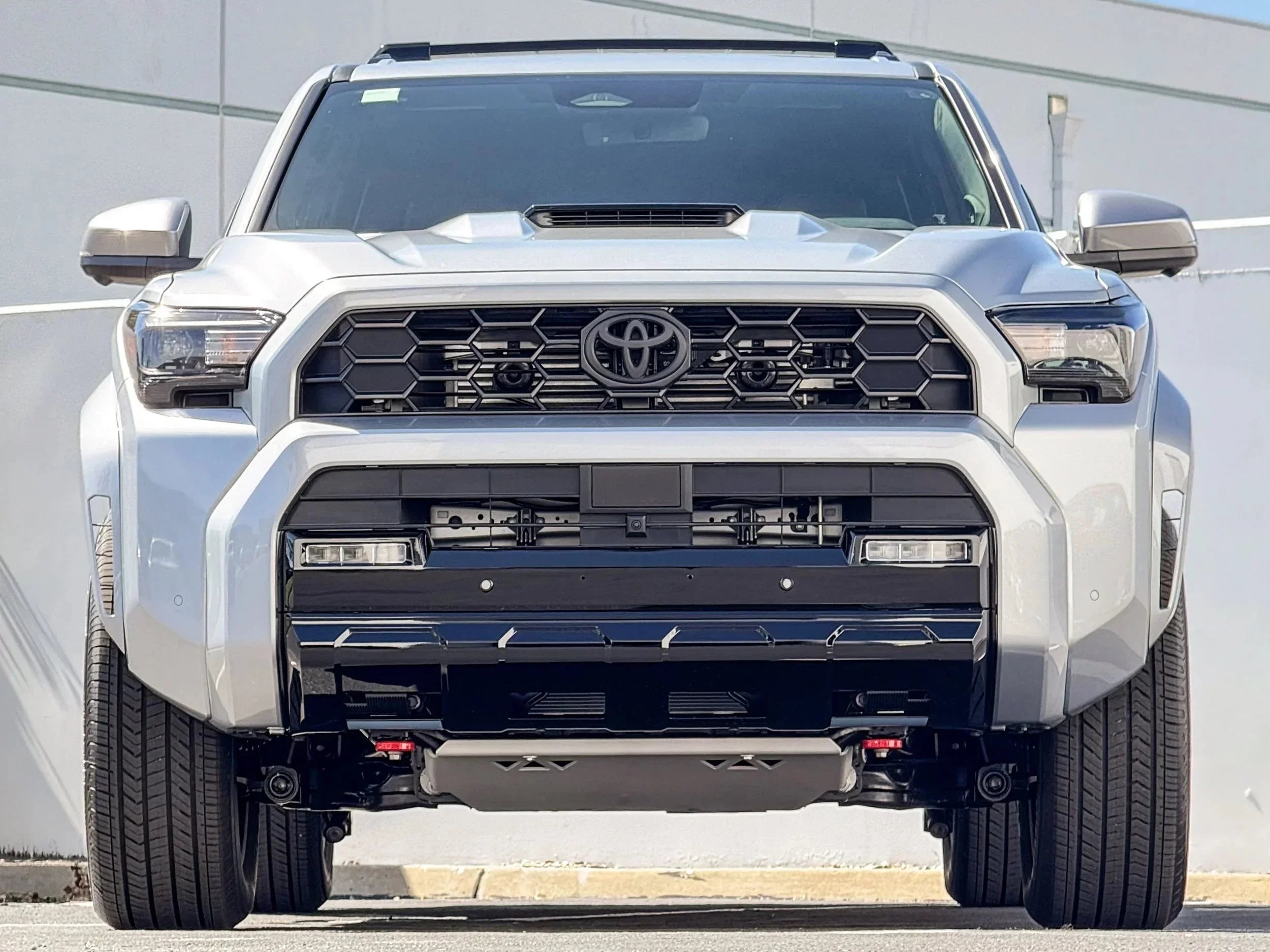 Front view of Toyota Tacoma with aftermarket off-road accessories and grille