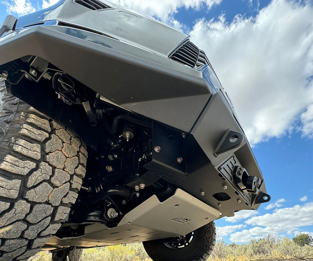 Heavy-duty off-road front bumper and skid plate on SUV with all-terrain tires outdoors