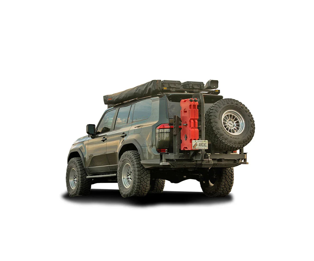 Rear view of an overland SUV with off-road tires, rooftop tent, roof rack, and spare tire