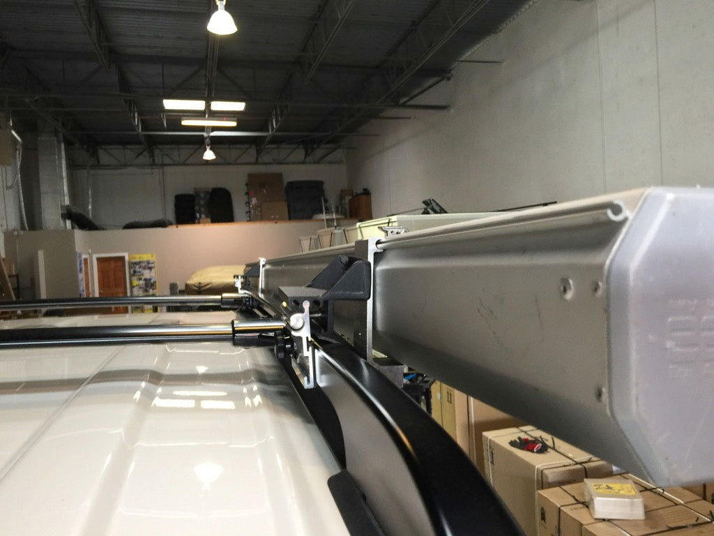 G clamp with S 2000 mount securing an awning to a vehicle roof rack in a garage