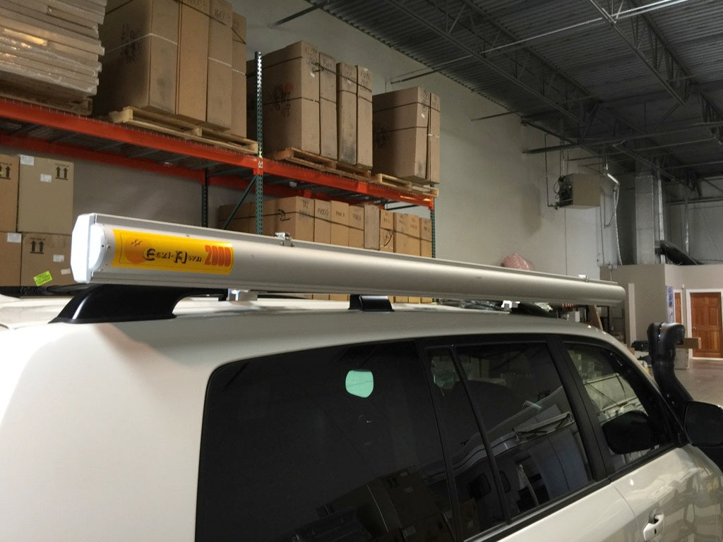 Awning mounted with G clamp and S 2000 mount on SUV roof rack inside warehouse