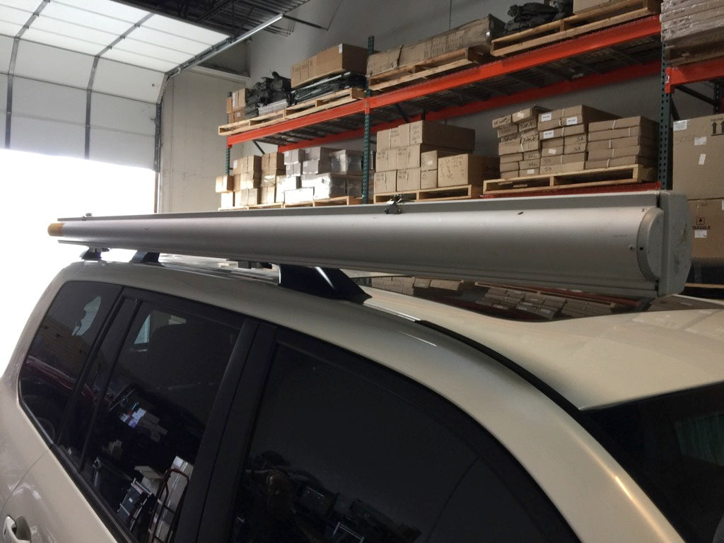 Vehicle roof rack with mounted awning using G clamp and S 2000 mount in warehouse