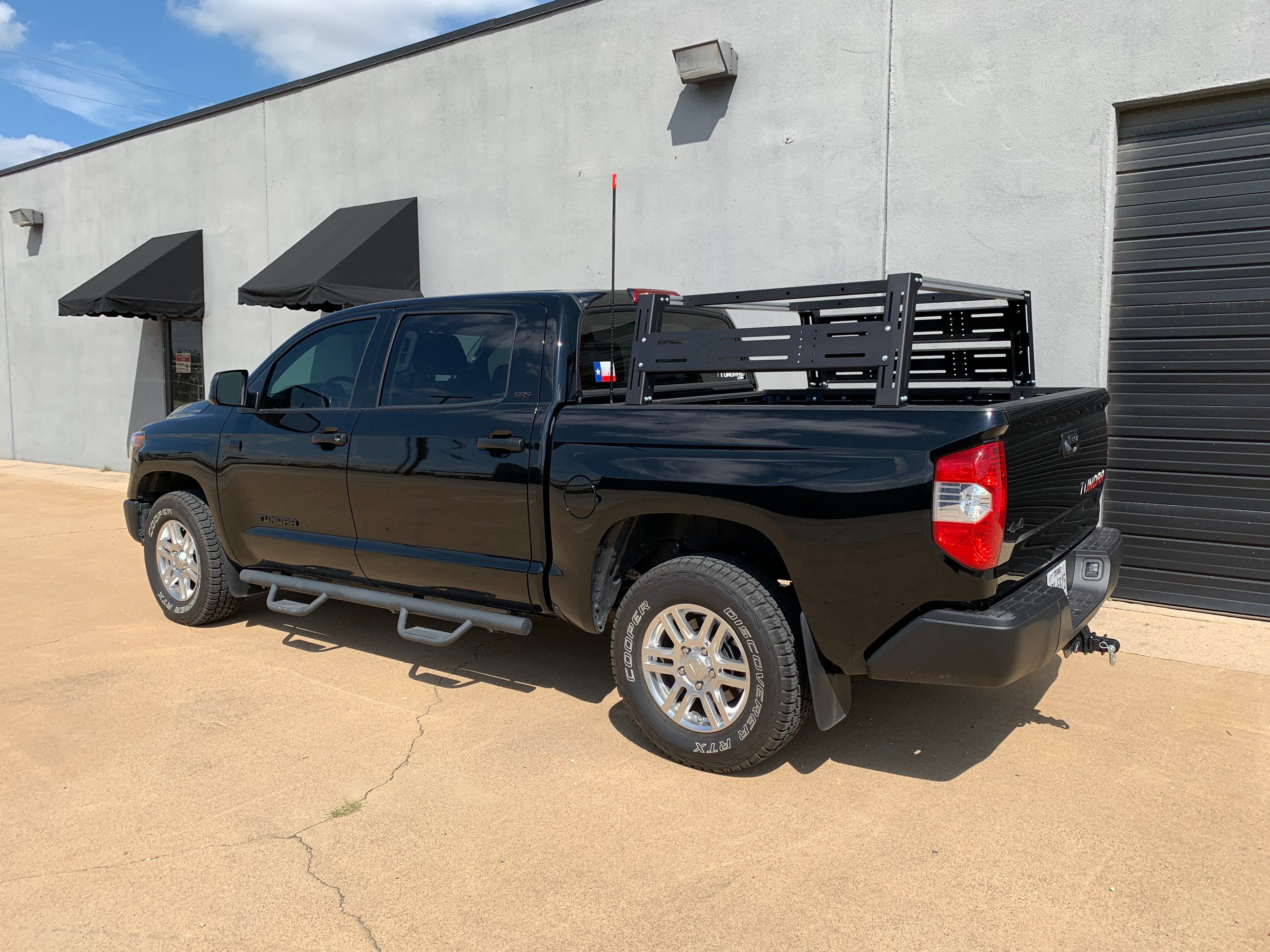 Black Toyota Tundra with overlanding bed rack parked outside, expedition gear ready