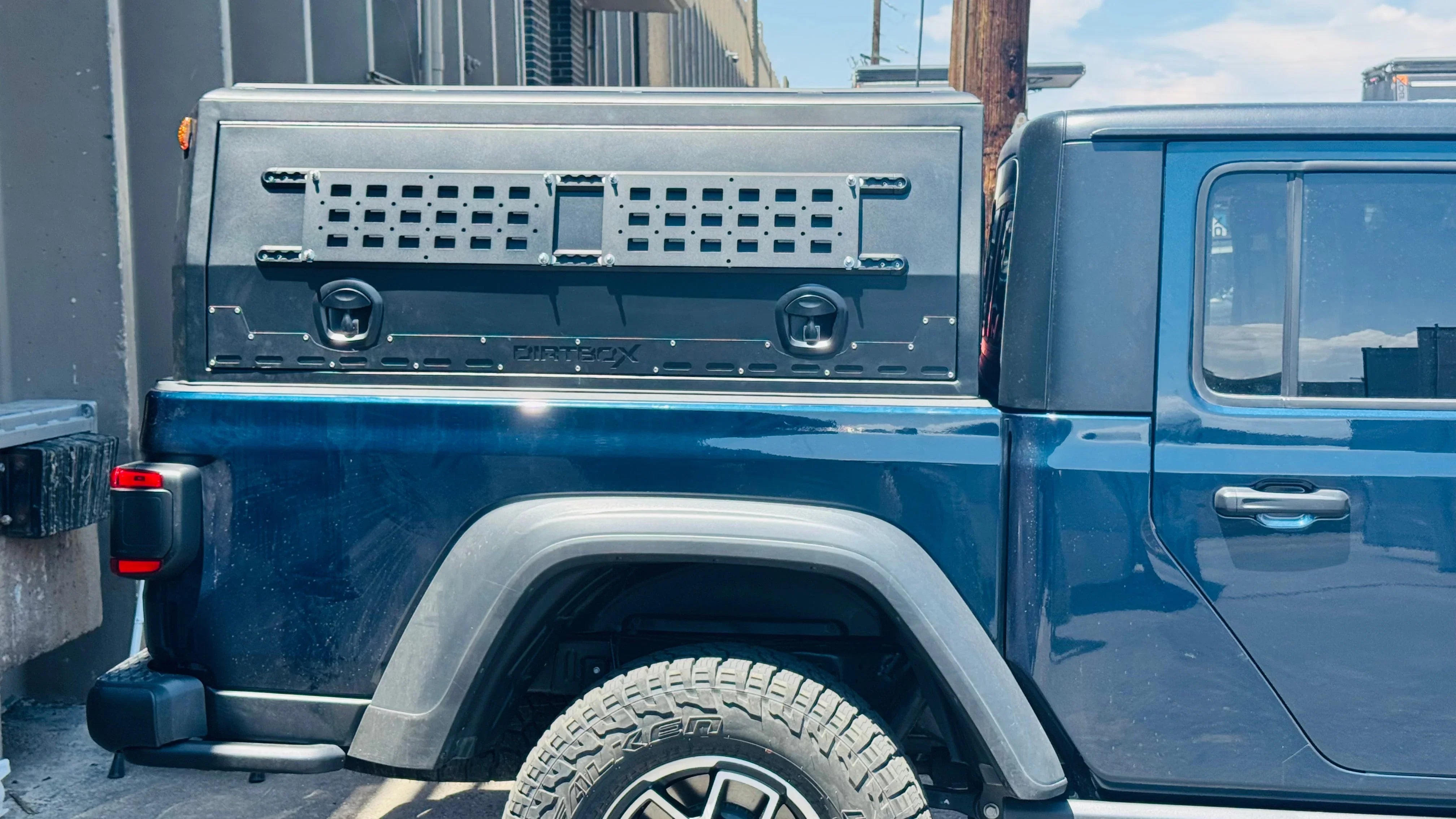 Jeep Gladiator with Dirtbox bed storage box, off-road tire, and modular accessory panel