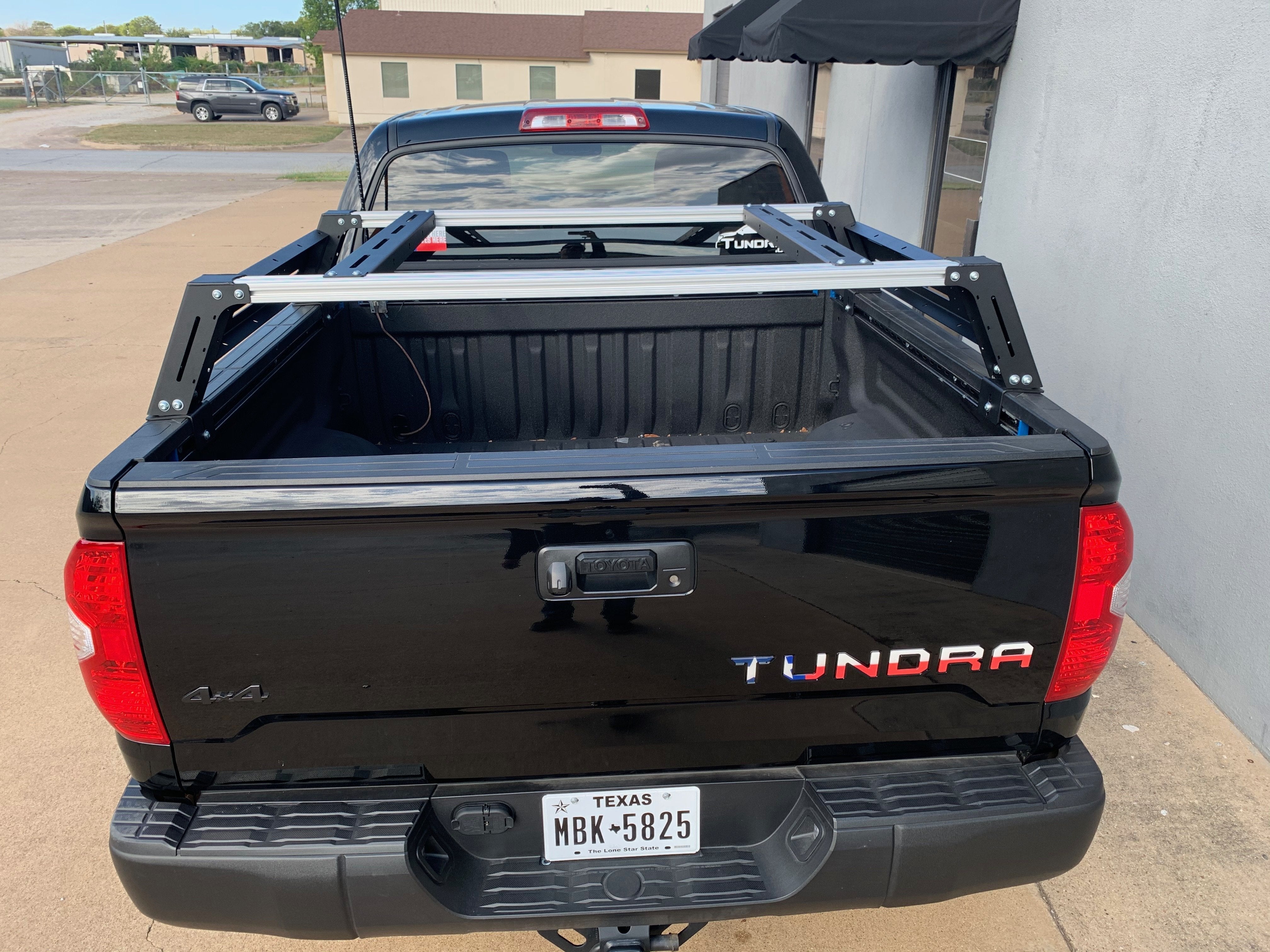 Overland bed rack installed on black Toyota Tundra truck for adventure and camping gear