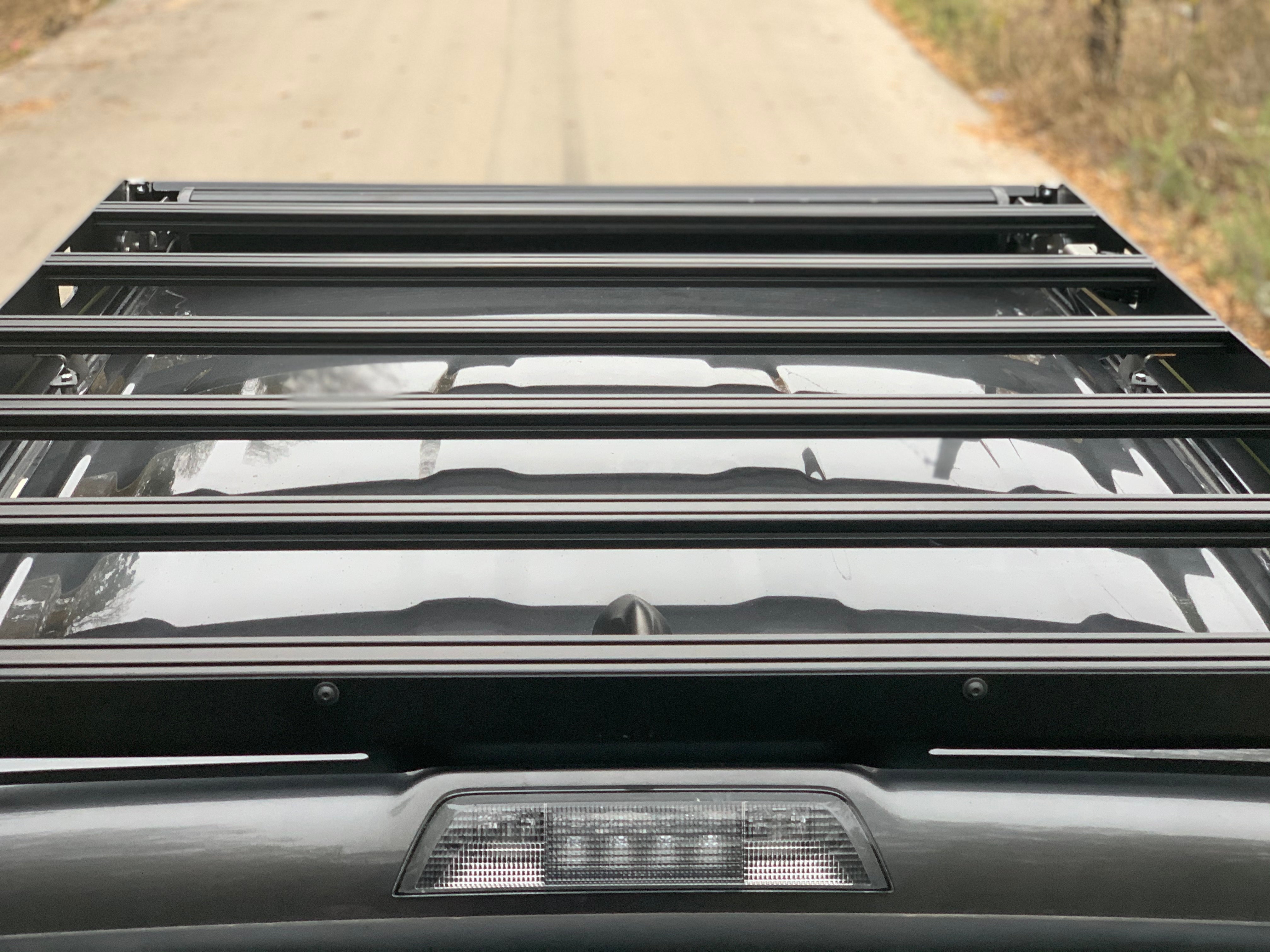 Heavy-duty roof rack installed on SUV, overlanding gear accessory on vehicle rooftop