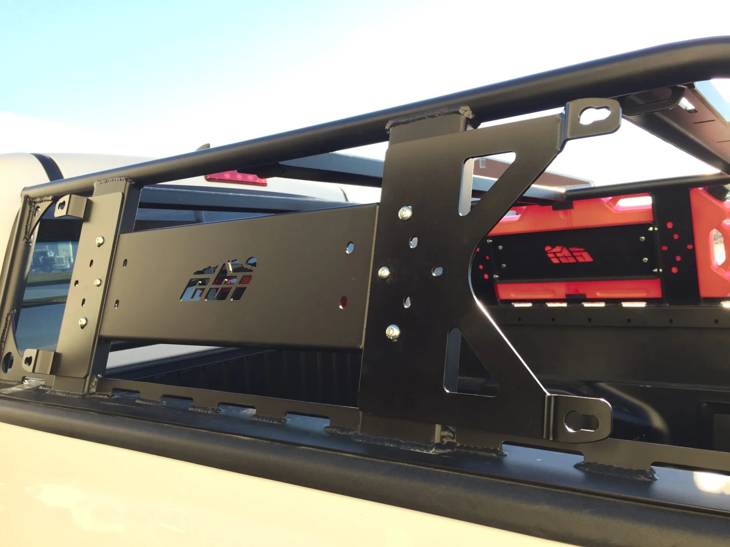 Close-up of black metal bed rack and red fuel can mounted on pickup truck for overlanding