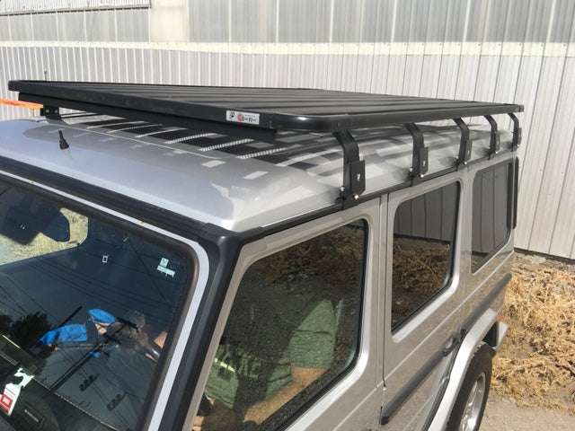 Metal roof rack mounted on silver SUV for overlanding and expedition gear