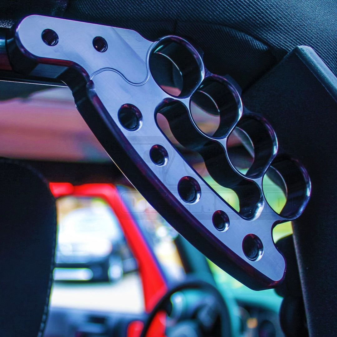 Heavy-duty aluminum grab handle installed on off-road vehicle roll bar, interior view