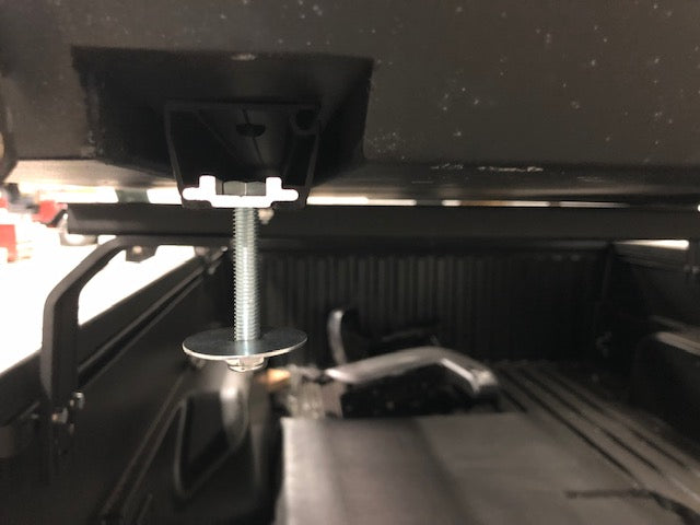 Close-up of a truck bed mounting bolt and bracket for overlanding gear installation