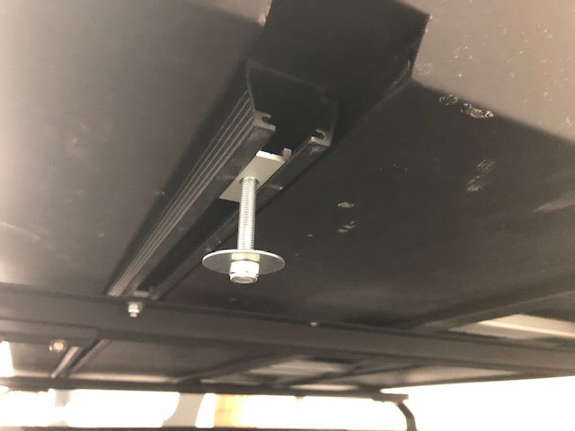 Close-up of mounting bolt and bracket for overland vehicle roof rack accessory installation