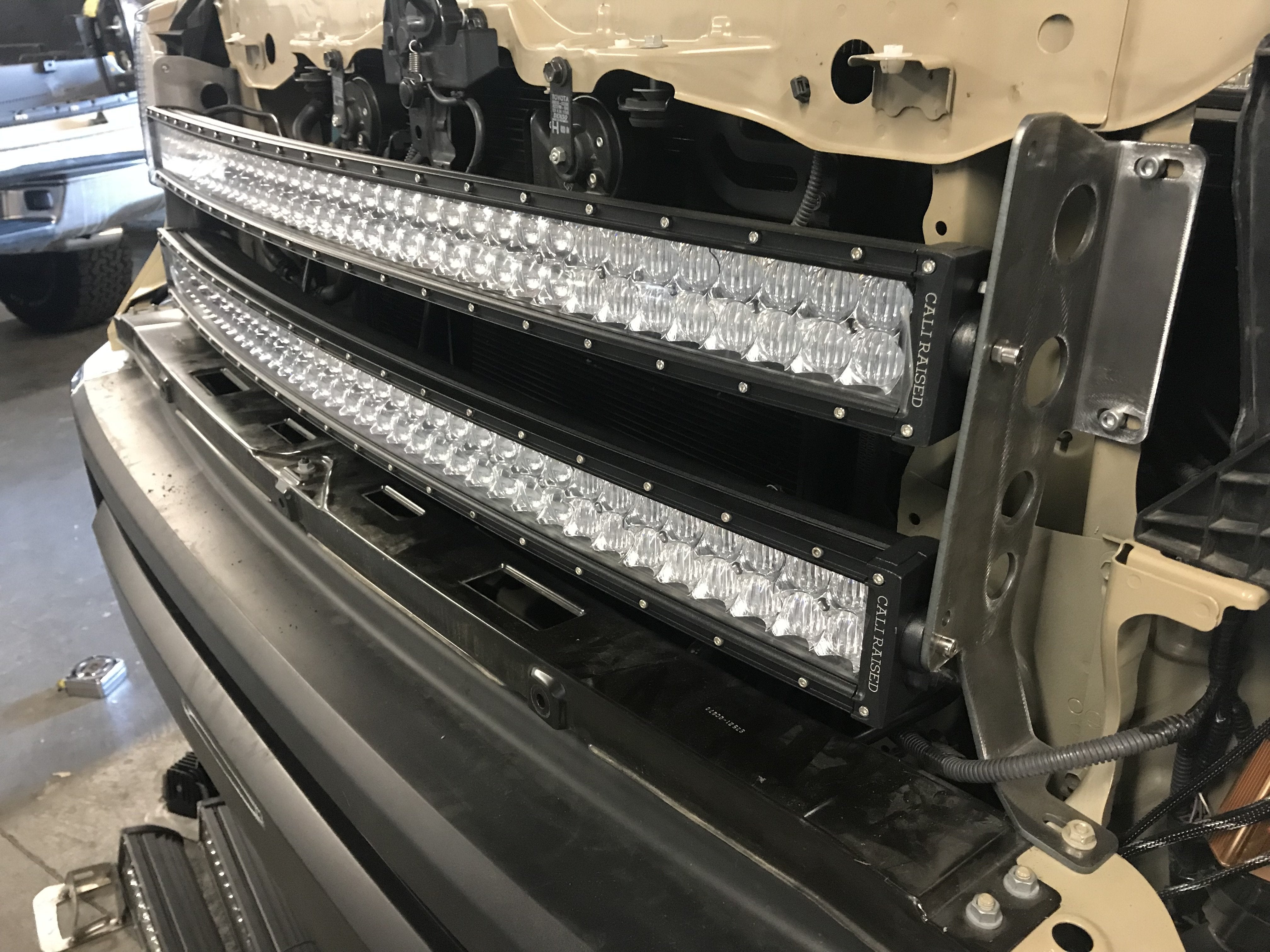 Dual LED light bars mounted on front grille of off-road vehicle
