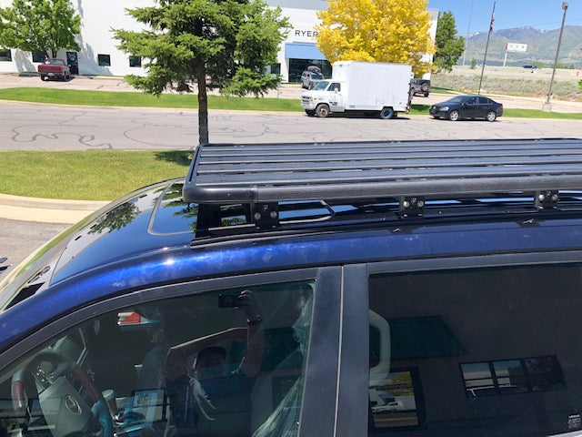 Overland roof rack installed on dark blue SUV, ideal for camping gear and adventure travel