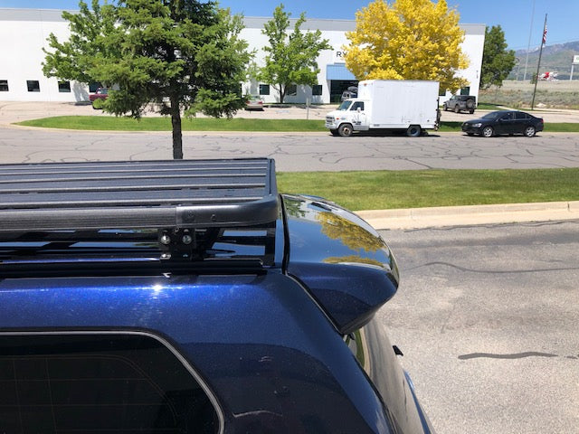 Roof rack mounted on a blue Toyota 4Runner SUV parked outdoors