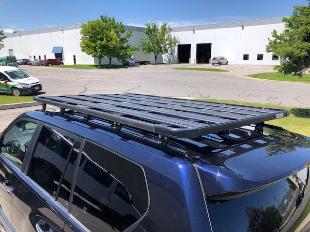 Overland roof rack installed on SUV in parking lot, ideal for expedition gear and camping