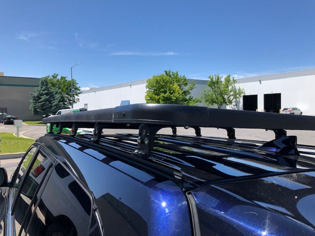Heavy-duty roof rack installed on a blue SUV for overlanding and adventure gear transport
