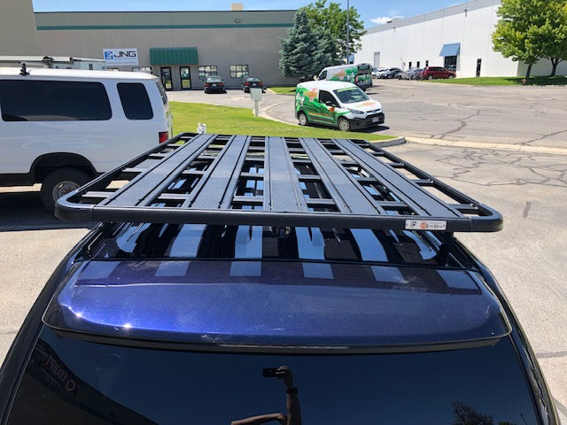 Black roof rack mounted on SUV for overlanding and adventure vehicle accessories