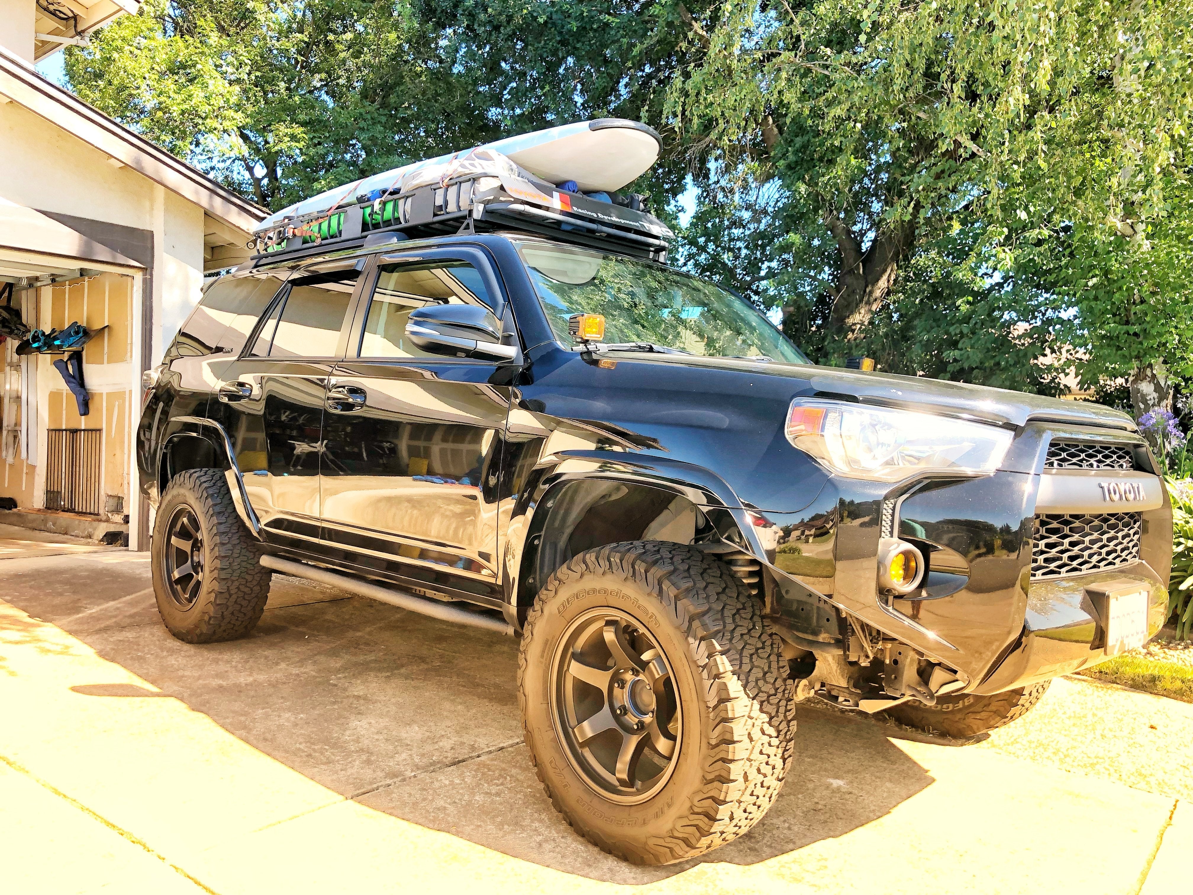 Black Toyota 4Runner with roof rack and gear for overlanding and expedition camping