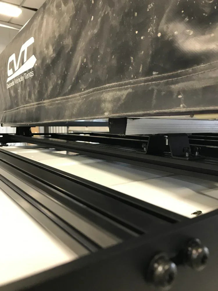 Close-up of CVT rooftop tent on black aluminum roof rack for overlanding vehicles