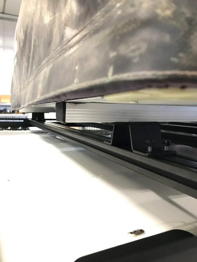 Close-up of roof rack system mounting hardware for overlanding vehicle accessories